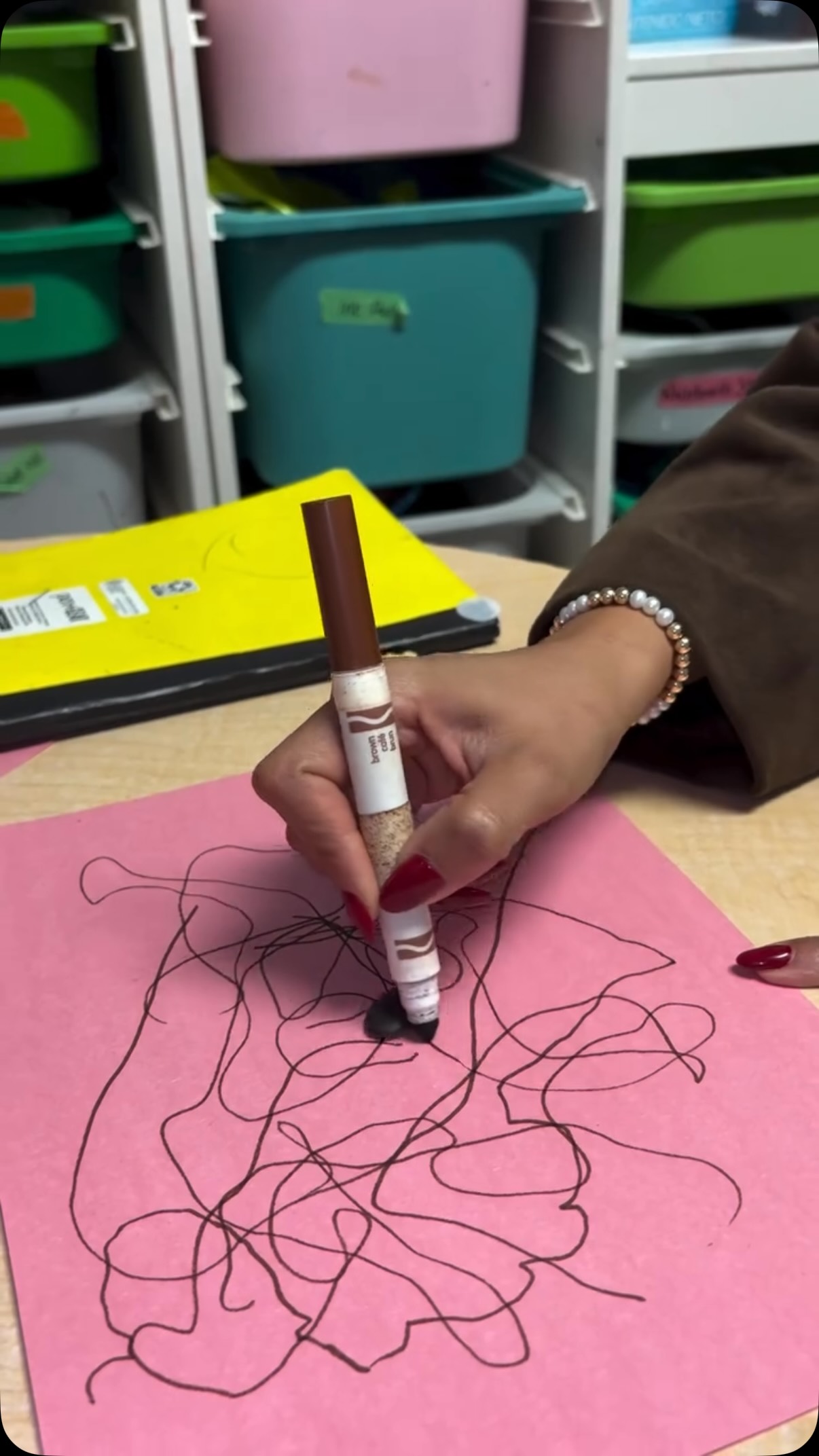 A child writing with a marker during a session
